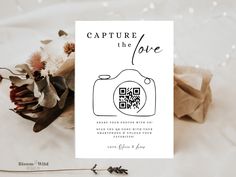 a white card with the words capture the love printed on it next to some flowers