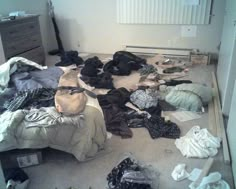 a messy room with clothes scattered all over the floor