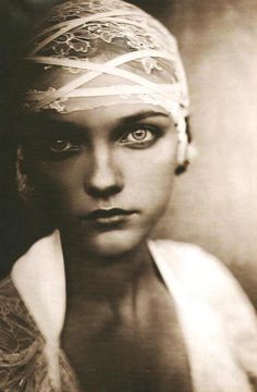 black and white photograph of a woman with bandaged headbands on her head