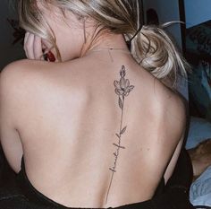 a woman with a flower tattoo on her back