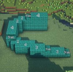 an aerial view of several blocks in the ground with numbers on them and one block below it