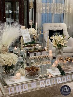 a table topped with lots of desserts and candles