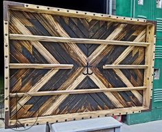 a large wooden box sitting on the side of a building