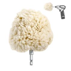 a white sheep is standing next to a hair dryer