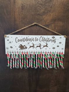 a sign hanging on the side of a wooden door that says, countdown to christmas