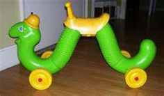 an inflatable green and yellow toy horse on wooden floor next to door way