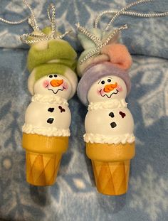 two ice cream cones with snowmen on them