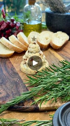 bread and rosemary on a cutting board with olives