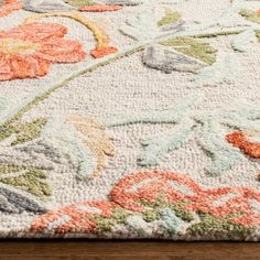 an area rug with flowers and leaves on it