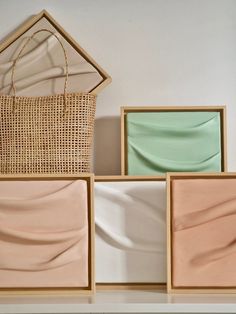 four different colored plates and a basket on a shelf