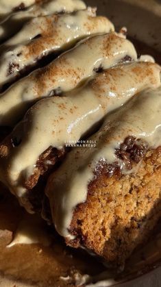 cinnamon roll with icing sitting on top of a plate