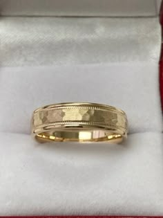 a gold wedding band in a box