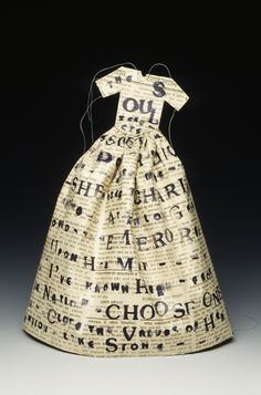 a dress made out of newspaper with words on it