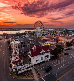 an aerial view of the boardwalk and ferris wheel at sunset