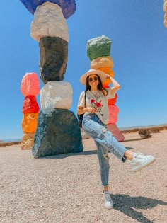 a woman posing in front of colorful rocks