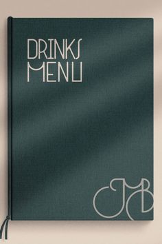 a green book with the words drink menu written in white ink on top of it