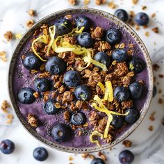 a bowl filled with blueberries and granola