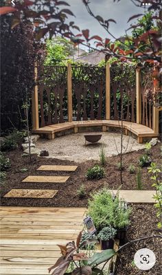 a wooden bench sitting in the middle of a garden