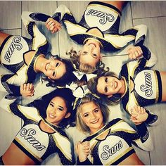 a group of cheerleaders standing in a circle