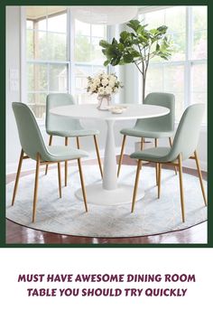 a dining room table with four chairs and a potted plant in the corner on top