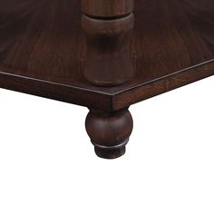 a close up of a wooden table with an odd shaped base on the top and bottom