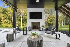 an outdoor living area with furniture and a fireplace