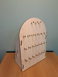 a wooden board with numbers on it sitting on a table next to a blue wall