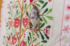 the wall is decorated with an intricately designed tree and bird motif on it's side