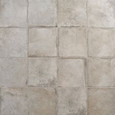 a white tiled floor with different shades of gray tiles on the top and bottom half