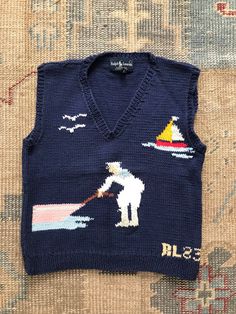 Vintage Ralph Lauren Hand Knit Sweater  Depicts a sailor anchoring or setting off in his/her boat Sweet and naive and whimsical  Beautiful vivid colors throughout; although their are slight discoloration aon the white of the sailors garment Old Blue Label Americana, Boating, Preppy, Handcraft Women's Size Large Approximate measurements inches: length from shoulder to bottom: 22 Chest or pit to pit: 38 Monogram Vest, Crochet Waistcoat, Black Crochet Top, Bohemian Clothes Women, Nautical Sweater, Nautical Outfits, Black Waistcoat, Boho Vest, Hand Knit Sweater