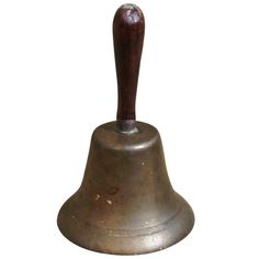 an old metal bell with a wooden handle