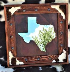 the texas state is reflected in an old wooden frame with metal rivets on it