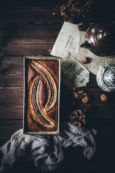 a loaf of bread sitting on top of a table next to nuts and other items