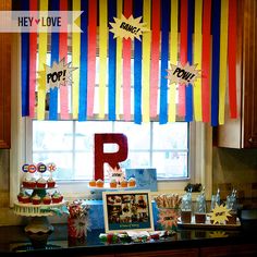 a kitchen counter with cupcakes and candy bar decorations