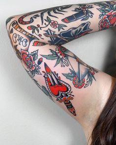 a woman with tattoos on her arms and legs