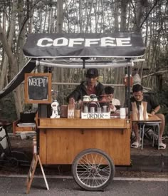 an outdoor coffee cart with people sitting at it