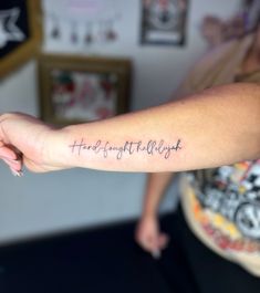 a person with a tattoo on their arm that reads, handwritten right - handed