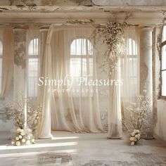 an empty room with sheer curtains and flowers