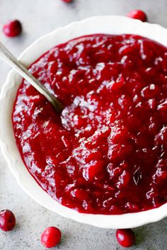 cranberry sauce in a white bowl with a spoon