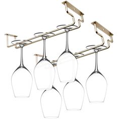 four wine glasses hanging from a metal rack with three hangers on it's sides