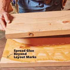 a person working on some wood with the words spread glue beyond it and layout marks below