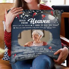 a woman sitting on a couch holding up a pillow with an image of her grandmother