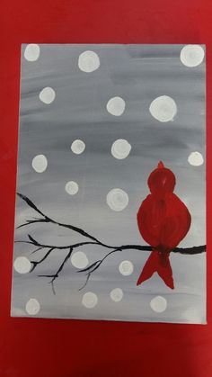 a painting of a red bird sitting on a branch with snow falling off the ground