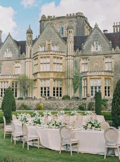 an outdoor dining table set up in front of a large building