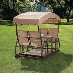 two chairs and an umbrella in the grass