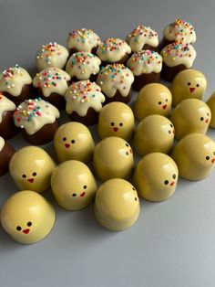 there are many small chocolates with sprinkles on them and one is yellow