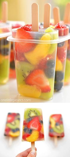 popsicles filled with fruit are sitting in plastic cups