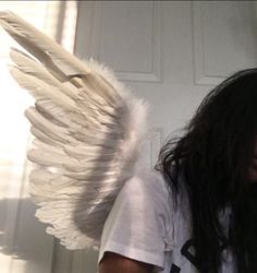 a woman with long hair and angel wings