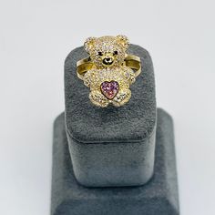 Rock a playful yet chic vibe with this 10K Gold Teddy Bear Ring, featuring dazzling CZ accents and a sweet pink heart. It's the perfect blend of cuteness and bling, making your style pop in the urban jungle. Teddy Bear is 21mm tall and 15mm wide. Teddy Bear Ring, Gold Teddy Bear, Bear Ring, Family Ring, Engraved Ring, Girl Friend, Rock A, Urban Jungle, Engraved Rings