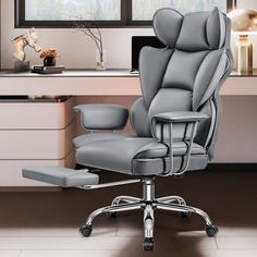 an office chair with foot rest in front of a window